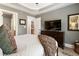 The main bedroom features carpet, furniture, and a large TV to relax and enjoy media at 2728 Wander Ln, Alpharetta, GA 30022