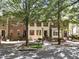 Charming townhomes in a row with brick and neutral siding, well-maintained front yards, and tree-lined street at 2728 Wander Ln, Alpharetta, GA 30022