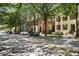 Street view of a row of townhomes with colorful exteriors and manicured lawns, showing neighborhood appeal at 2728 Wander Ln, Alpharetta, GA 30022