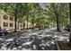 Tree lined street with parked cars near multi-story townhomes at 2728 Wander Ln, Alpharetta, GA 30022