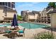 Community pool with lounge chairs, table and chairs, and landscaping at 3655 Habersham Ne Rd # 203, Atlanta, GA 30305