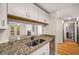 Updated kitchen featuring granite countertops, white cabinets, and stainless steel appliances at 3655 Habersham Ne Rd # 203, Atlanta, GA 30305