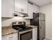 Close up on stainless steel appliances, granite countertops and white cabinets at 3655 Habersham Ne Rd # 203, Atlanta, GA 30305
