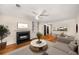 Bright living room featuring a fireplace, built-in shelving, and hardwood floors, seamlessly connecting to the kitchen at 3655 Habersham Ne Rd # 203, Atlanta, GA 30305