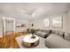 Open living room layout featuring hardwood floors, a ceiling fan, and seamless access to kitchen and entrance at 3655 Habersham Ne Rd # 203, Atlanta, GA 30305