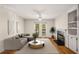 Bright living room with fireplace, built-in shelving, hardwood floors, and French doors offering abundant natural light at 3655 Habersham Ne Rd # 203, Atlanta, GA 30305