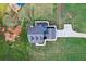 Aerial view of a house with a patio, driveway and expansive green lawn at 615 Henderson Mill Rd, Covington, GA 30014