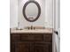 Bathroom featuring wood vanity, granite countertop, oval mirror and white walls at 615 Henderson Mill Rd, Covington, GA 30014