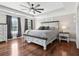 Spacious main bedroom boasts hardwood floors, a tray ceiling with fan, and natural light, offering relaxation at 615 Henderson Mill Rd, Covington, GA 30014