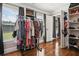 Well-lit closet with wood floor features rod, shelves, and window for a bright and organized space at 615 Henderson Mill Rd, Covington, GA 30014