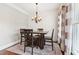 Elegant dining area featuring hardwood floors, natural light, and a comfortable setting for memorable meals at 615 Henderson Mill Rd, Covington, GA 30014