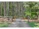 Scenic driveway leading through a wooded area, framed by a wooden fence at 615 Henderson Mill Rd, Covington, GA 30014