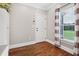 Inviting entryway featuring hardwood floors, a window, and a white door at 615 Henderson Mill Rd, Covington, GA 30014