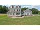 Inviting two-story home featuring a charming front porch and well-maintained front yard at 615 Henderson Mill Rd, Covington, GA 30014