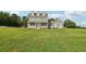 Charming home with a welcoming front porch and manicured lawn with greenery in the background at 615 Henderson Mill Rd, Covington, GA 30014