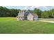 Charming two-story home boasts lush green lawn and an attached garage, a perfect blend of comfort and convenience at 615 Henderson Mill Rd, Covington, GA 30014