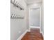 Hallway with coat hooks and hardwood floors leads to adjacent rooms, offering practical storage at 615 Henderson Mill Rd, Covington, GA 30014