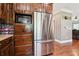 Sleek kitchen boasts stainless steel appliances, dark wood cabinetry, and hardwood floors, perfect for cooking enjoyment at 615 Henderson Mill Rd, Covington, GA 30014