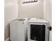 Laundry room with white washer and dryer, light fixture and white panelled wall at 615 Henderson Mill Rd, Covington, GA 30014