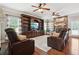 Cozy living room with a stone fireplace, hardwood floors, and a built-in entertainment center, ideal for gatherings at 615 Henderson Mill Rd, Covington, GA 30014