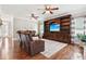 Spacious living room features hardwood floors, a built-in entertainment center, and comfortable seating at 615 Henderson Mill Rd, Covington, GA 30014