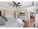 Bright bedroom features hardwood floors, tray ceilings, and adjoins a closet and bathroom, offering convenience at 615 Henderson Mill Rd, Covington, GA 30014