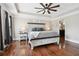 Spacious main bedroom boasts hardwood floors, a tray ceiling with fan, and natural light, offering relaxation at 615 Henderson Mill Rd, Covington, GA 30014