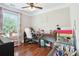 Bright office space with hardwood floors, lots of light and a wooden desk at 615 Henderson Mill Rd, Covington, GA 30014