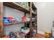 Spacious pantry features wooden shelving stocked with various food items, adding storage for everyday essentials at 615 Henderson Mill Rd, Covington, GA 30014