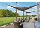Inviting patio with comfortable seating, shade cover and string lights at 615 Henderson Mill Rd, Covington, GA 30014