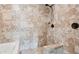 Walk-in shower with beige tile walls, seating, and dark fixtures for a luxurious bath experience at 615 Henderson Mill Rd, Covington, GA 30014