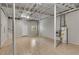 Unfinished basement featuring laminate floors, white support pillars, and a water heater at 1368 Poplar Pointe Se, Smyrna, GA 30082