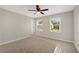 Bedroom featuring neutral carpeting, a ceiling fan, and large windows at 1368 Poplar Pointe Se, Smyrna, GA 30082
