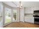 Bright eat-in kitchen with white cabinets, stainless appliances, and bay window at 1368 Poplar Pointe Se, Smyrna, GA 30082