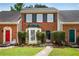 Charming brick townhouse with neatly trimmed bushes and walkway to the front door at 1368 Poplar Pointe Se, Smyrna, GA 30082