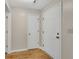 Neutral hallway with wood-look flooring and white doors at 1368 Poplar Pointe Se, Smyrna, GA 30082