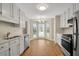 Open kitchen with breakfast nook featuring stainless steel appliances and white cabinets at 1368 Poplar Pointe Se, Smyrna, GA 30082