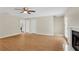 Bright living room features wood flooring, a ceiling fan, and a fireplace at 1368 Poplar Pointe Se, Smyrna, GA 30082