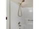 Shower stall with an adjustable, hand-held shower head and built-in shelf at 1368 Poplar Pointe Se, Smyrna, GA 30082