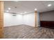 Renovated basement area features recessed lighting, and new vinyl flooring at 148 Bramble Oak Dr, Woodstock, GA 30188