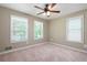 Bright bedroom with three windows and ceiling fan at 148 Bramble Oak Dr, Woodstock, GA 30188