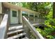 Inviting front entrance with steps leading up to the deck and the front door of the house at 148 Bramble Oak Dr, Woodstock, GA 30188