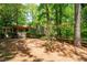 Charming exterior featuring well-maintained landscaping and a peaceful setting among mature trees at 148 Bramble Oak Dr, Woodstock, GA 30188