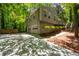 View of the home's exterior showcasing a two-car garage and driveway at 148 Bramble Oak Dr, Woodstock, GA 30188