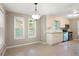 Bright kitchen features tile floors, white cabinets, and stainless steel appliances at 148 Bramble Oak Dr, Woodstock, GA 30188