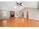 Spacious living room featuring hardwood floors, a vaulted ceiling, and a cozy stone fireplace at 148 Bramble Oak Dr, Woodstock, GA 30188