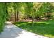 Landscaped front yard with lush green grass and a long driveway leading to the house at 148 Bramble Oak Dr, Woodstock, GA 30188