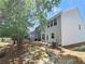 View of backyard with lawn and trees, along with the side of the home at 2141 Spikerush Way, Buford, GA 30519