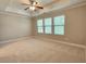 Large bedroom features a ceiling fan and a bank of windows that let in light at 2141 Spikerush Way, Buford, GA 30519