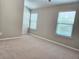 Bedroom with plush carpet, neutral walls, and bright windows at 2141 Spikerush Way, Buford, GA 30519